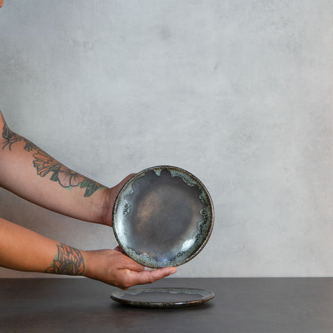 Two Hands Holding an Onyx Cafe Plate