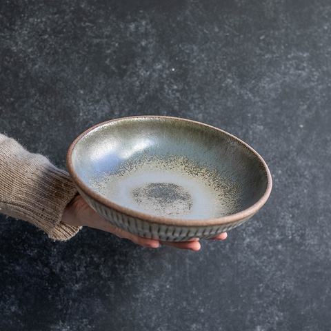 Hand holding a Progress Stu Bowl, displaying the Moonshadow interior glaze and etched exterior texture