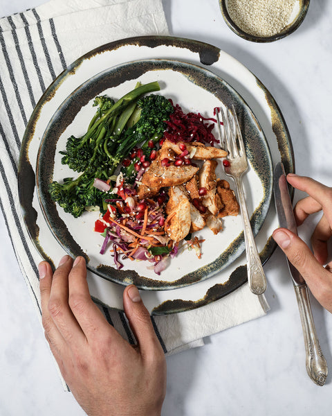 Inkblot Salad and Dinner plate in use, presenting a meal of chicken and broccoli 