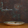 Side view of Handmade Serving Platter Glazed in Inkblot: Elegant Large White Plate with Striking Black Rim
