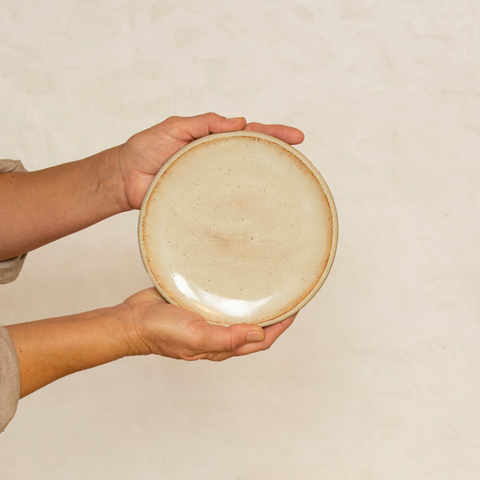 Two Hands Holding a Workshop Cafe Plate